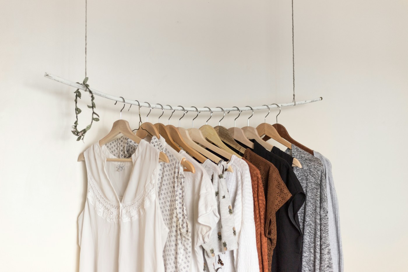 Light neutral clothing hanging on a rail